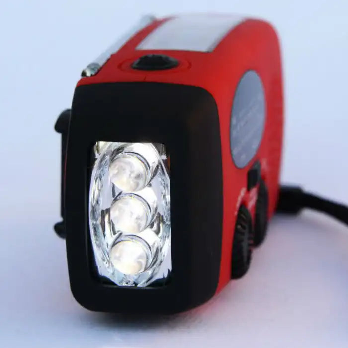 Survival Radio close-up showing three bright LED flashlight bulbs for power outage or camping.