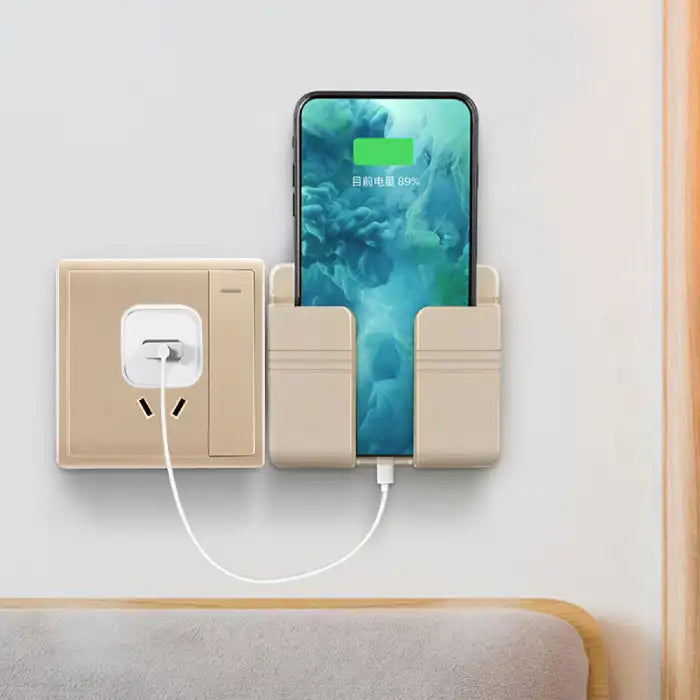 Beige wall mount phone holder in use charging smartphone above bedside table with matching outlet