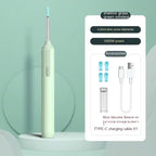 Green wireless ear cleaner with accessories including four blue silicone tips and USB-C cable