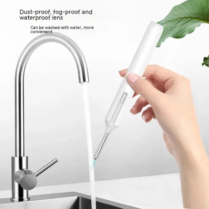 Wireless ear cleaner being rinsed under faucet showing waterproof and washable design